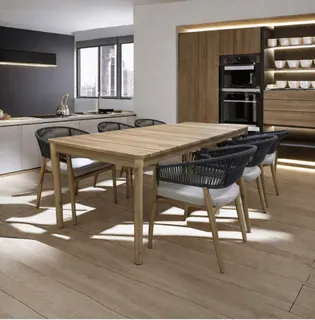 Dining table and woven chairs in a modern kitchen