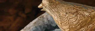 Close-up of a gold-toned sculptural bird or animal form