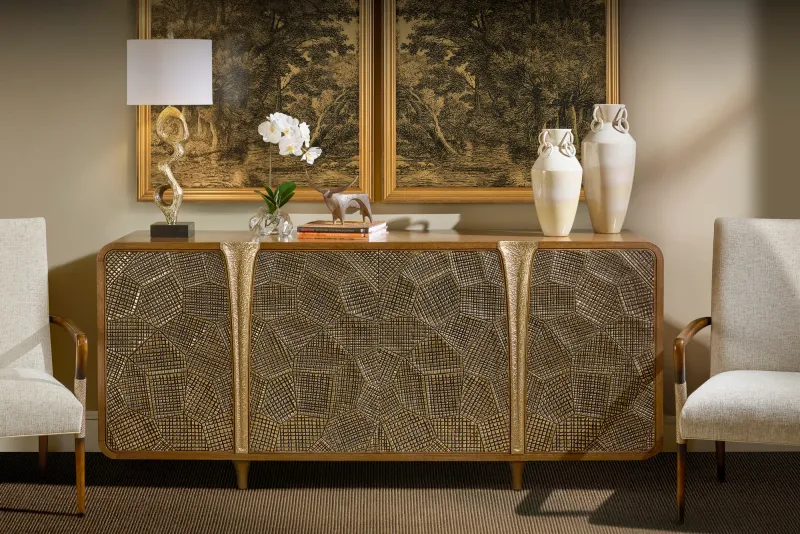 Gold-accented sideboard displayed between two upholstered chairs