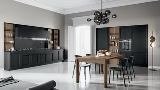 Black paneled kitchen cabinets with wood dining table and chairs