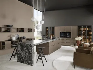 Modern taupe kitchen cabinets with a marble island and integrated appliances