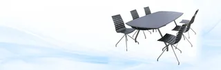 Dark oval dining table surrounded by six black slatted chairs.