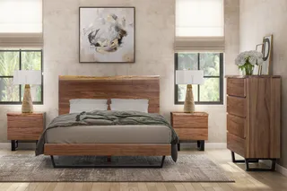 Wood bed, bedside tables and tall dresser in a bedroom