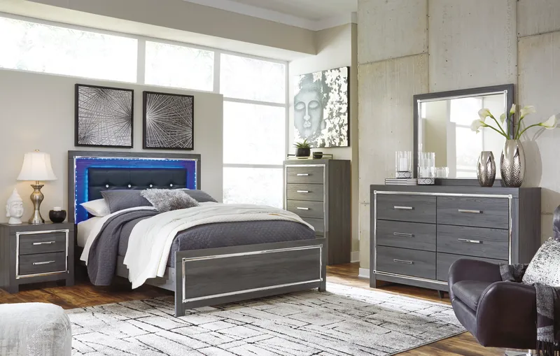 Gray bedroom furniture set with bed, nightstands, dresser, and mirror