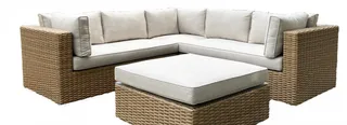 Woven outdoor sectional sofa with white cushions and matching square ottoman.