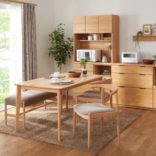 Wood dining table, chairs and matching storage cabinets in a dining room