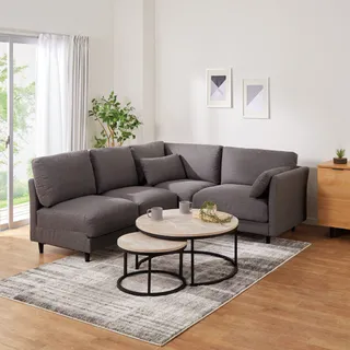 Gray corner sofa with round nesting tables in a living room