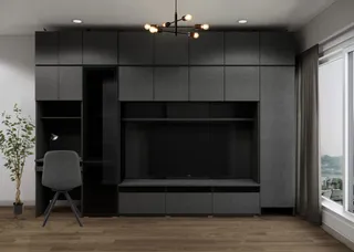 Dark built-in storage and television wall with a chair in a modern room