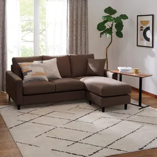 Brown sectional sofa with cushions, side table and rug
