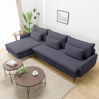 Dark blue sectional sofa with cushions and round coffee tables