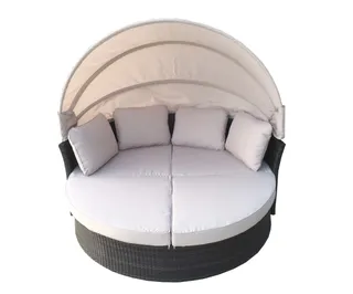 Round woven outdoor daybed with cushions and fabric canopy