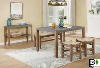 Wood dining table with matching stools and a console table in a bright room.