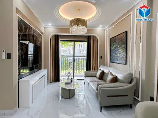 Apartment living room with grey sofa, media console, chandelier and balcony