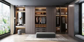 Built-in dressing room with dark wardrobes, display shelving and central bench