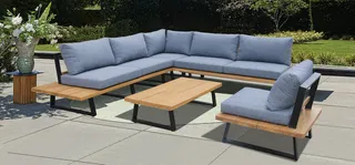 Blue-gray outdoor sectional sofa, lounge chair and wooden coffee tables.