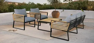 Outdoor gray-cushioned sofa and armchairs with wooden slat frames and coffee table.