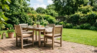 Outdoor wooden dining table and four chairs on a brick patio