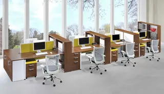 Open-plan office workstation row with desks, cabinets, monitors and chairs