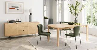 Dining room with wooden table, green chairs and matching sideboard