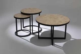 Set of round tables with parquet-patterned tops and black metal bases.