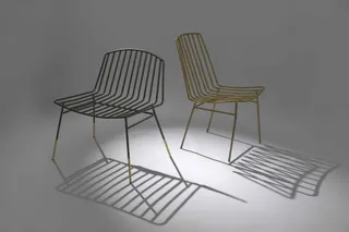 Two metal-framed lounge chairs with contrasting wire designs.