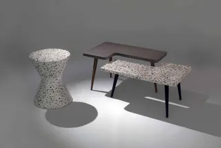 Set of tables and a terrazzo-style stool in a studio setting.