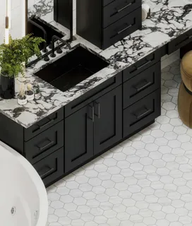 Black bathroom vanity with marble countertop, sink and hexagonal tile floor