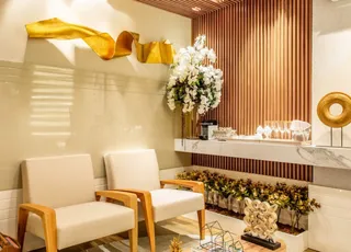 Finished interior with lounge chairs, wood slat wall, bar counter and floral decor