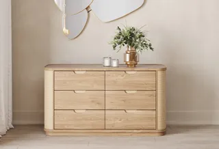 Light wood six-drawer dresser with rounded woven-style side panels