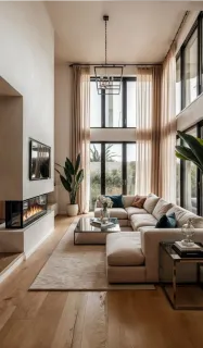 Modern living room with a large sectional sofa, fireplace and wood flooring.