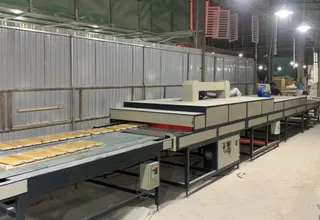 Furniture panel production line inside a factory