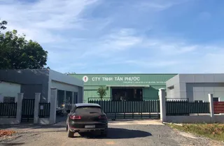 Front entrance of Tan Phuoc furniture factory with company signage