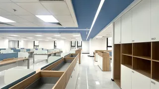 Modern open-plan office fitted with desks, storage cabinets and workstations