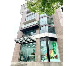 Exterior of a multi-storey TAV office and showroom with glass frontage