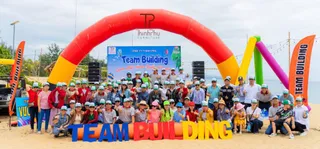 Large staff group gathered at an outdoor team-building event