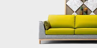 Bright yellow upholstered sofa with gray side panels