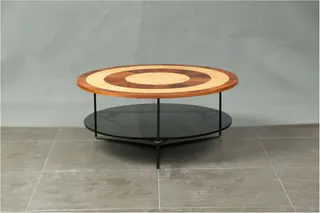 Round coffee table with patterned wooden top and glass lower shelf
