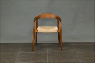 Wooden armchair with a woven seat and curved backrest
