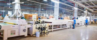 Large woodworking production line with machinery, ducts and workers