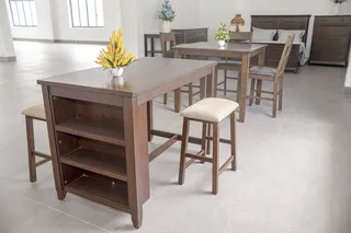 Wooden dining tables, chairs and stools arranged in a bright showroom