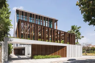 Modern house with timber sunshades, glass walls and landscaped frontage