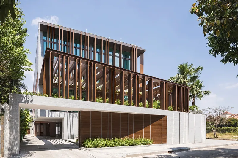 Modern house with timber sunshades, glass walls and landscaped frontage