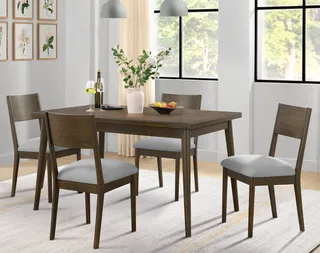 Dark wood dining table with four gray upholstered chairs