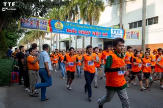 Employees taking part in a company running event outside