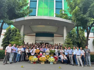 Large company group gathered outside a building entrance