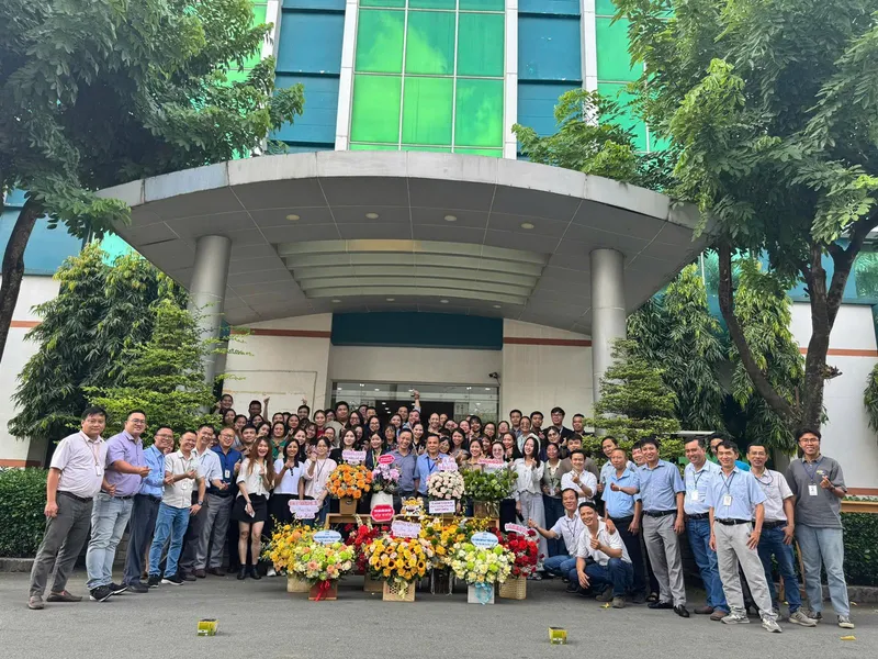 Large company group gathered outside a building entrance
