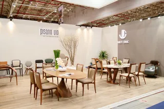 Viet Duc exhibition stand displaying dining tables, chairs and lounge furniture.