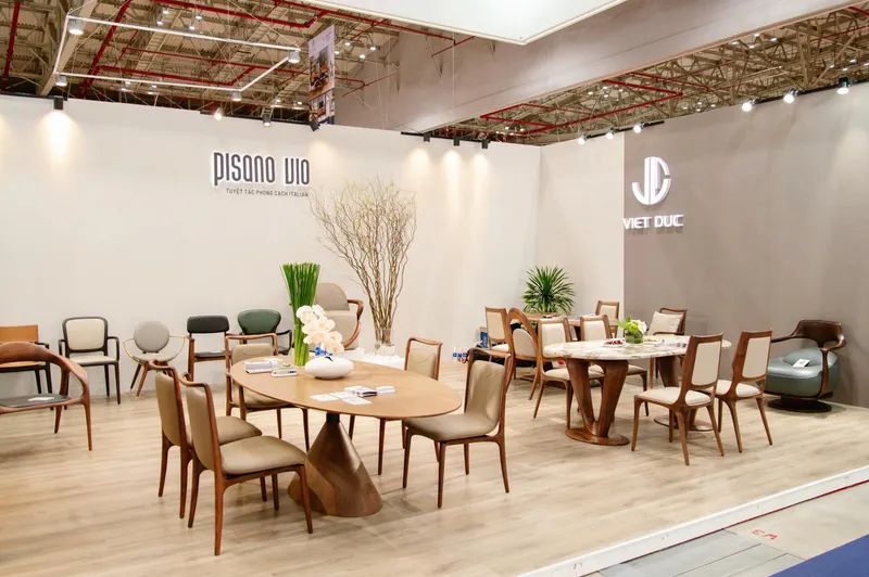 Viet Duc exhibition stand displaying dining tables, chairs and lounge furniture.