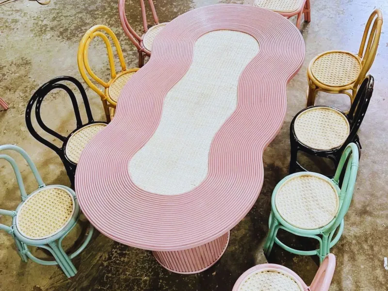 Colorful woven rattan table surrounded by matching chairs