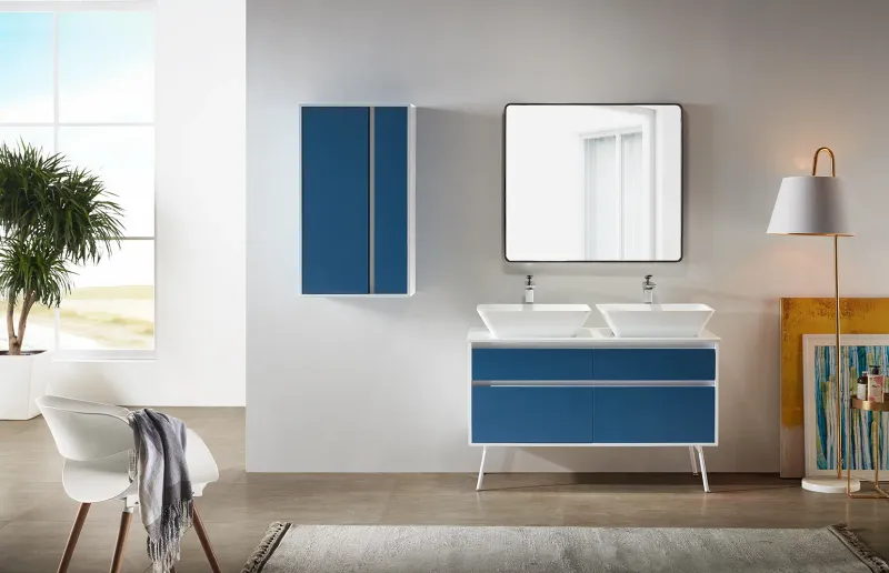 Blue and white double-sink bathroom vanity with mirror in a furnished interior.